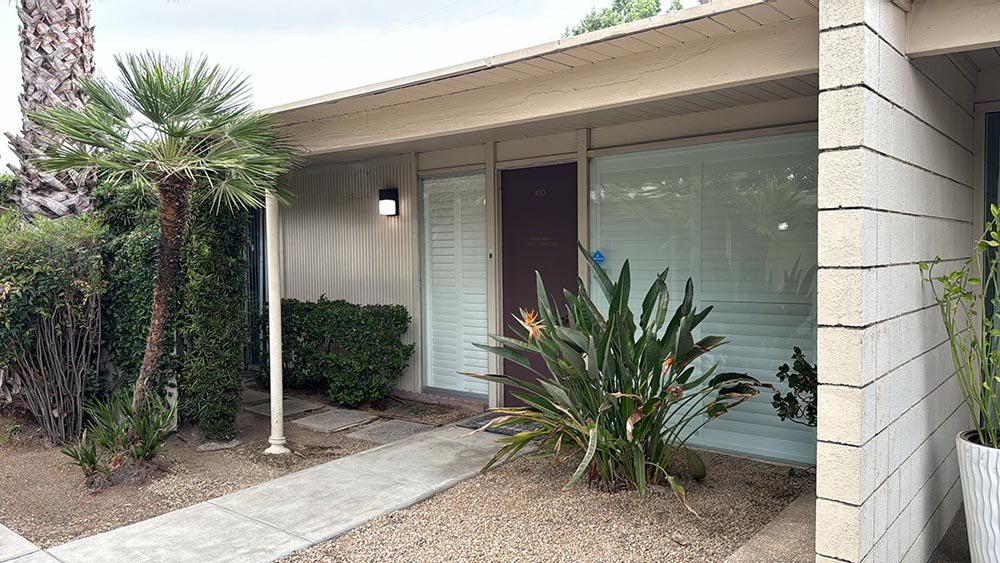 a house with a door and plants