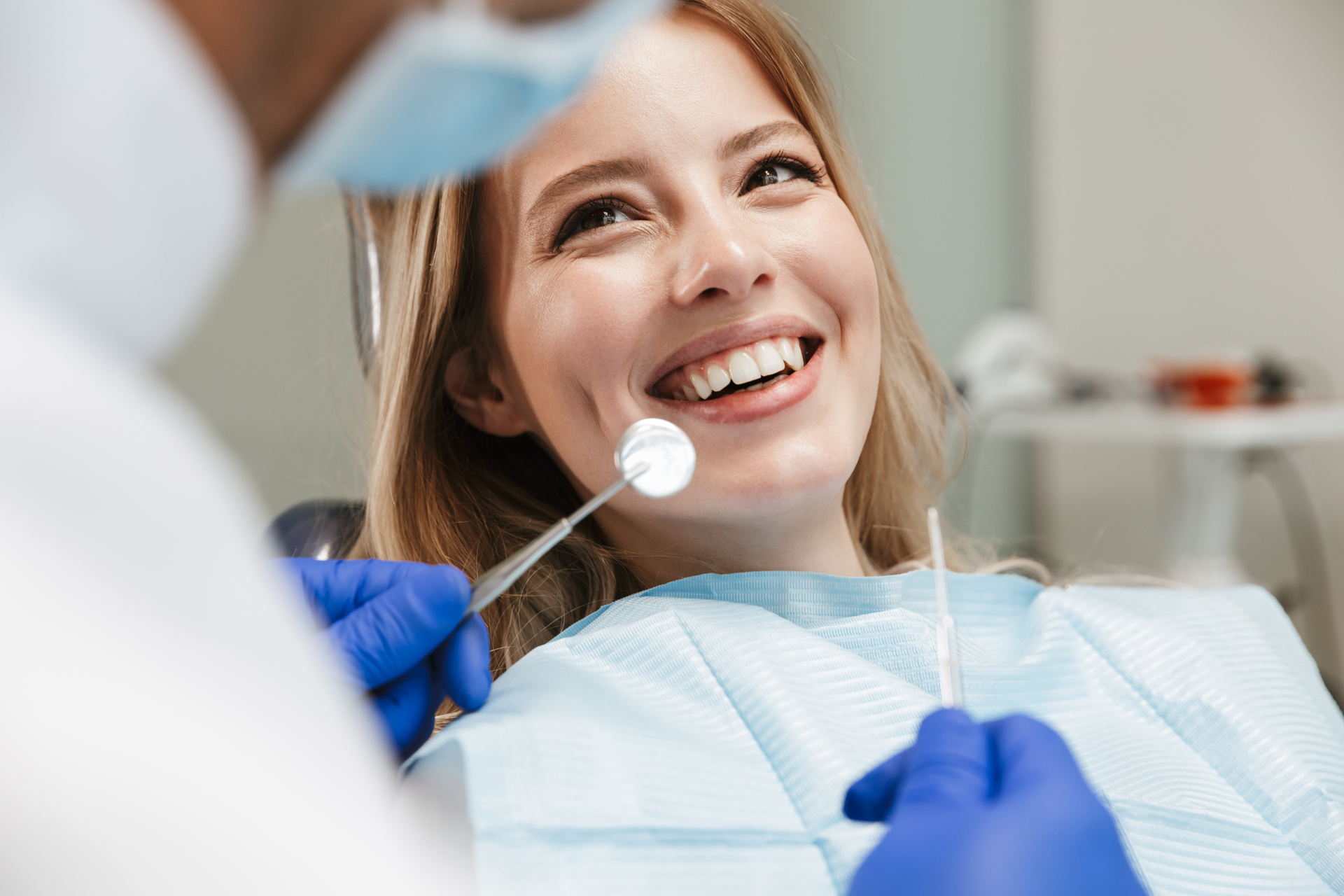 a woman smiling at a dentist