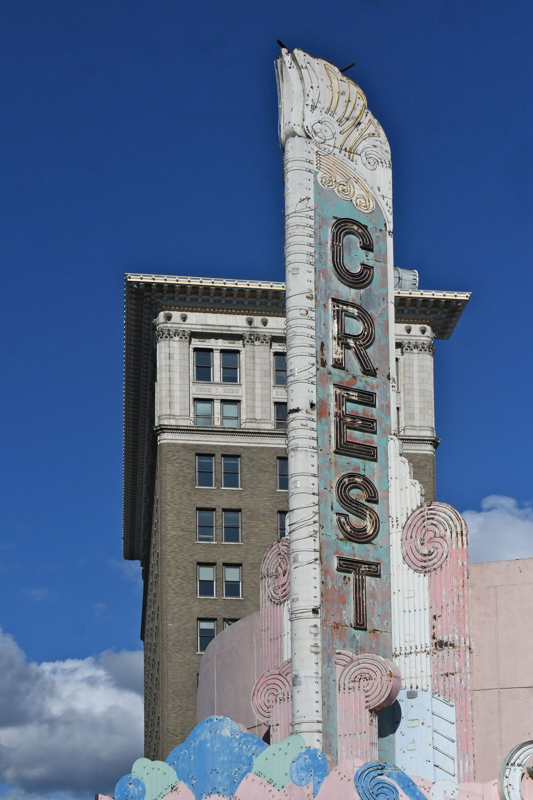 a sign with a tall building in the background